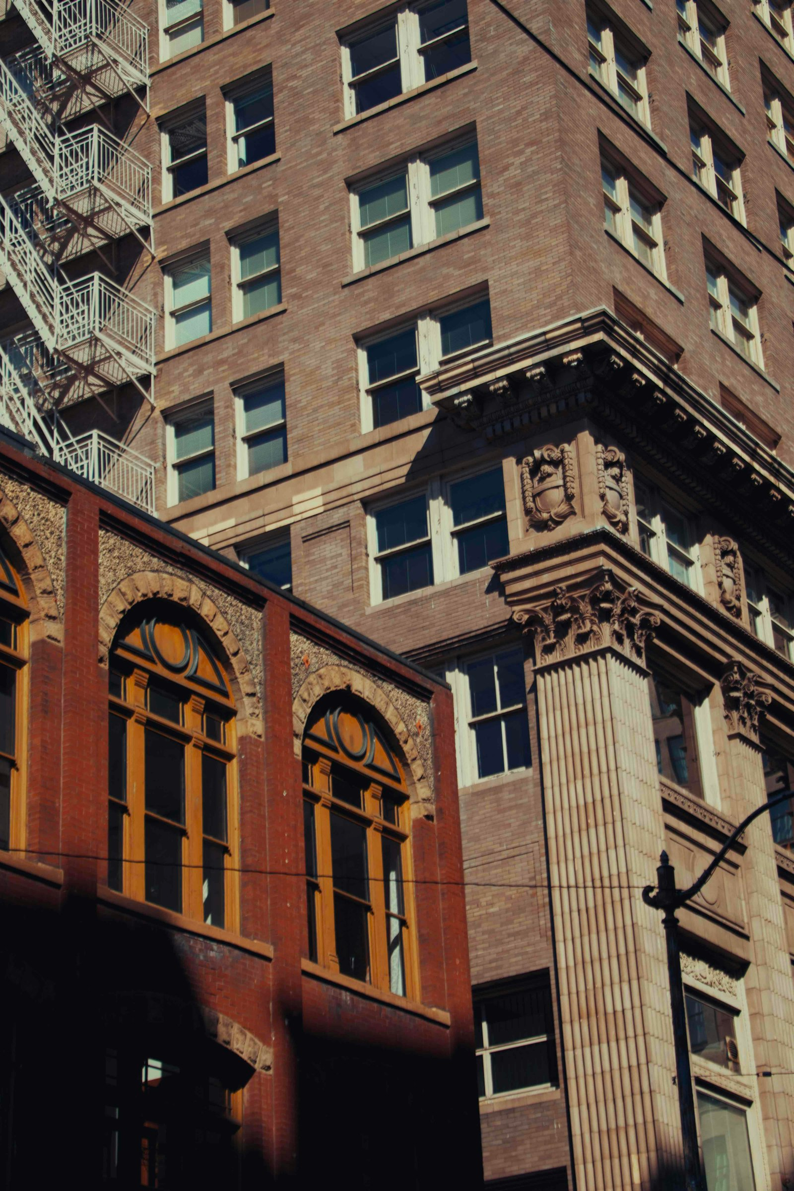 Historic brick commercial buildings with arched windows in a downtown district